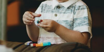 boy holding block toy