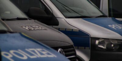 a row of police vans parked next to each other