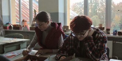 a group of people sitting at a table working on a project