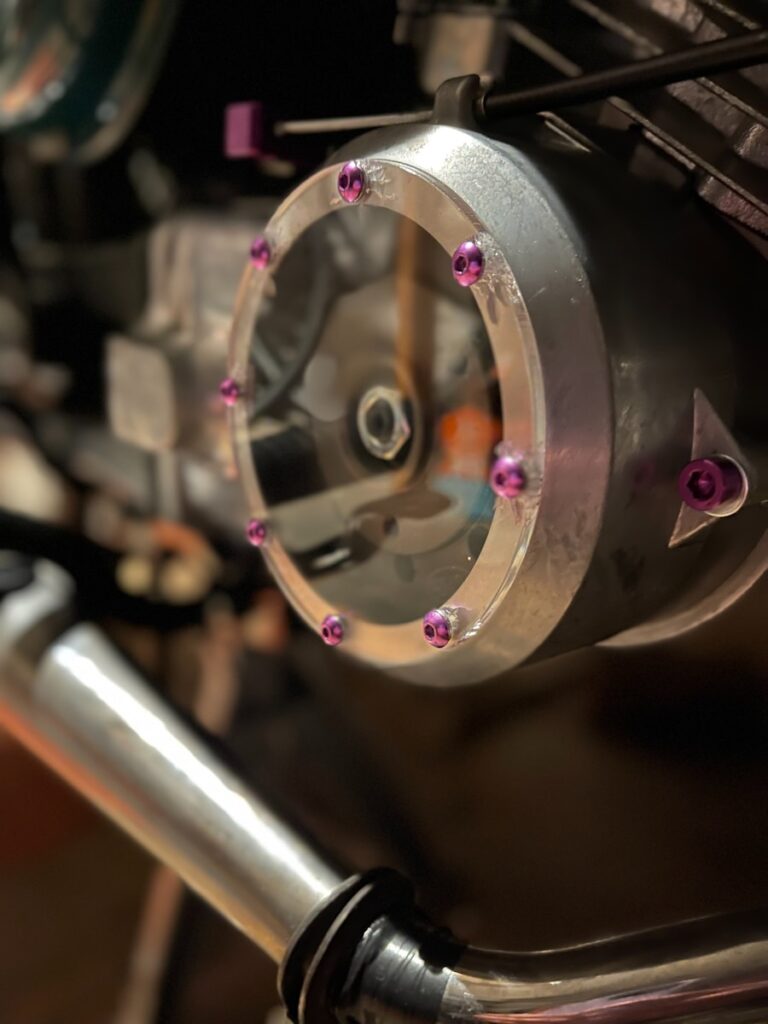 a close up of a metal object with pink flowers on it