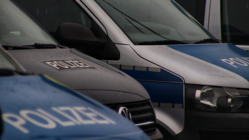 a row of police vans parked next to each other