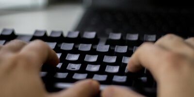 a person typing on a computer keyboard