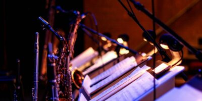 brass saxophone on white music stand