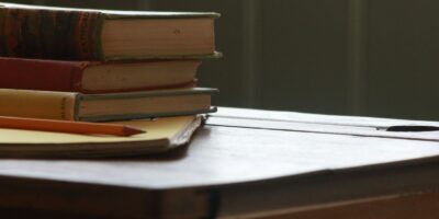 books and pencil on wooden table