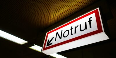 a red and white sign hanging from the ceiling