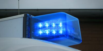 a blue light on top of a white truck